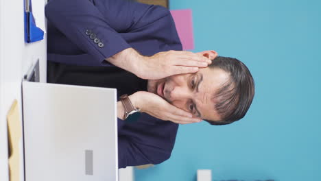 Vertical-video-of-Businessman-sad-seeing-his-failure-on-laptop.